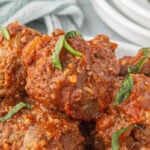 Slow cooker porcupine meatballs stacked in a crockpot.