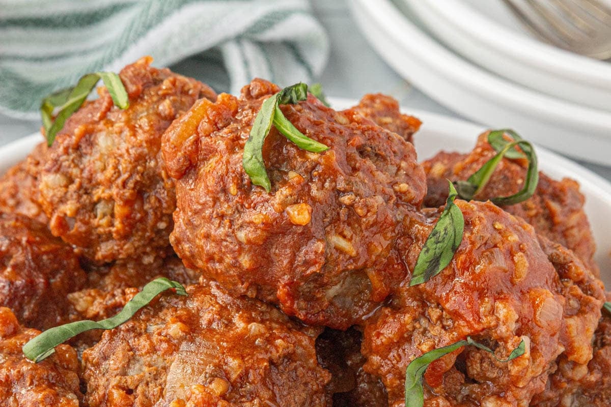 Slow cooker porcupine meatballs stacked in a crockpot.