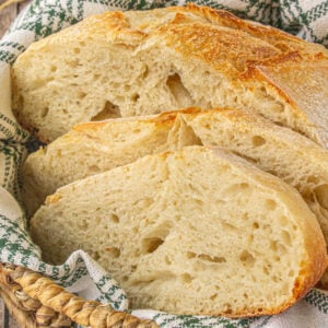 Sliced sourdough bread loaf in a bread basket.