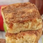 Apple snickerdoodle bars cut and stacked on a server. Title text overlay for Pinterest.