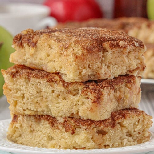 A stack of snickerdoodle apple bars on a plate.