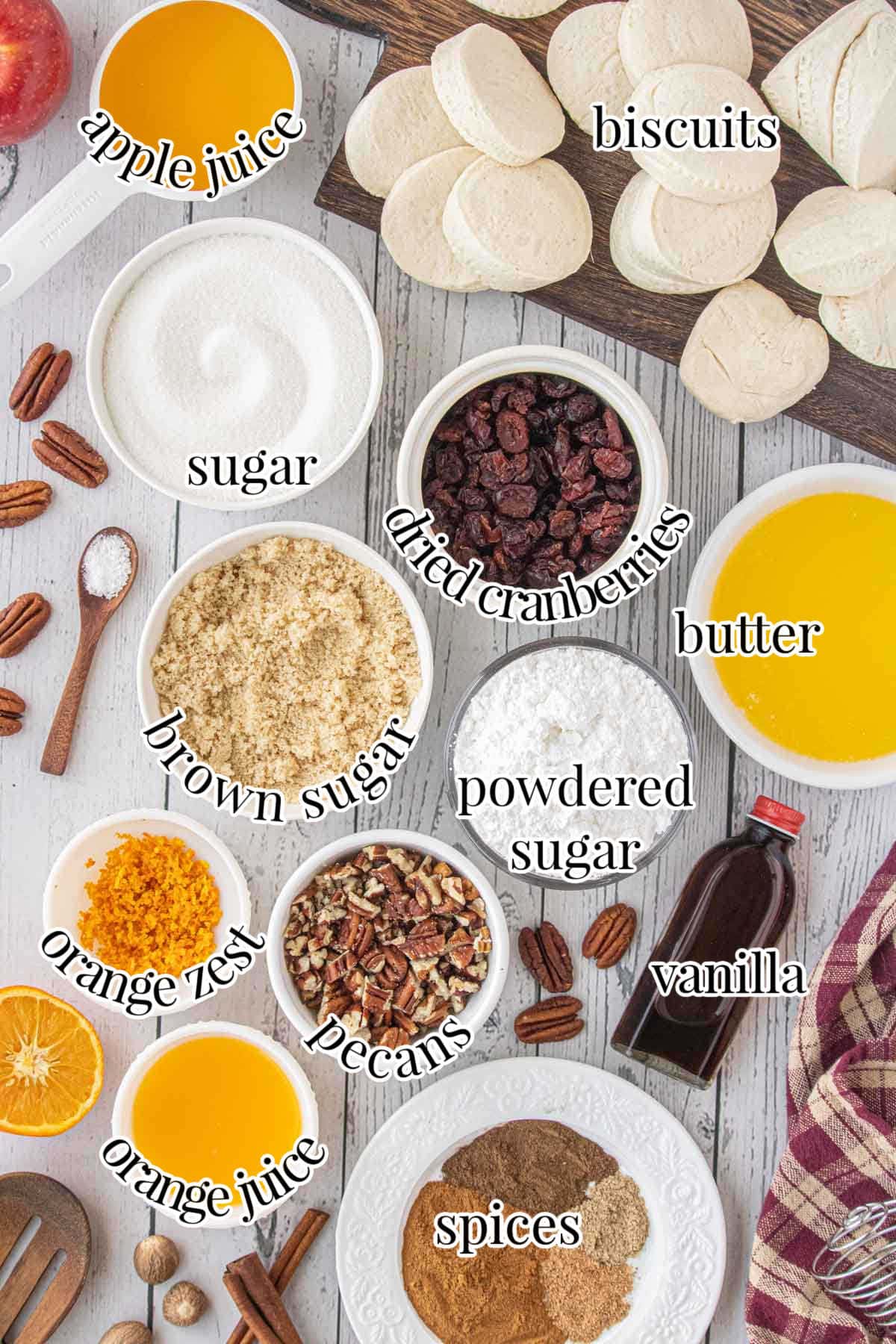 Labeled ingredients for crockpot monkey bread includes dried cranberries, pecans, and orange juice and zest.