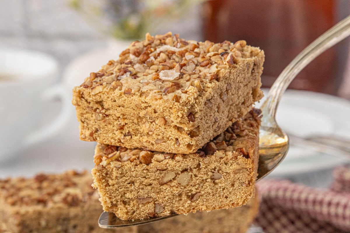 Homemade maple pecan blondies on a server, easy blondie recipe with maple syrup and toasted pecans.
