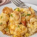 Closeup of a plate of cauliflower casserole with a fork nearby.