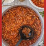 A tall Pinterest graphic showing a pot of stuffed cabbage roll soup with a black ladle in the center. The top text reads “Stuffed Cabbage Roll Soup,” and the bottom text says “Dinner for Emotionally Exhausted Adults.” The soup is thick, hearty, and tomato-rich, photographed overhead in a large skillet.