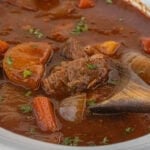 Close-up of Guinness beef stew showing chunks of beef and vegetables in thick stout-based gravy