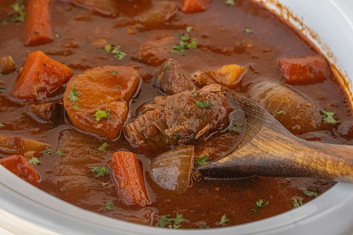 Close-up of Guinness beef stew showing chunks of beef and vegetables in thick stout-based gravy