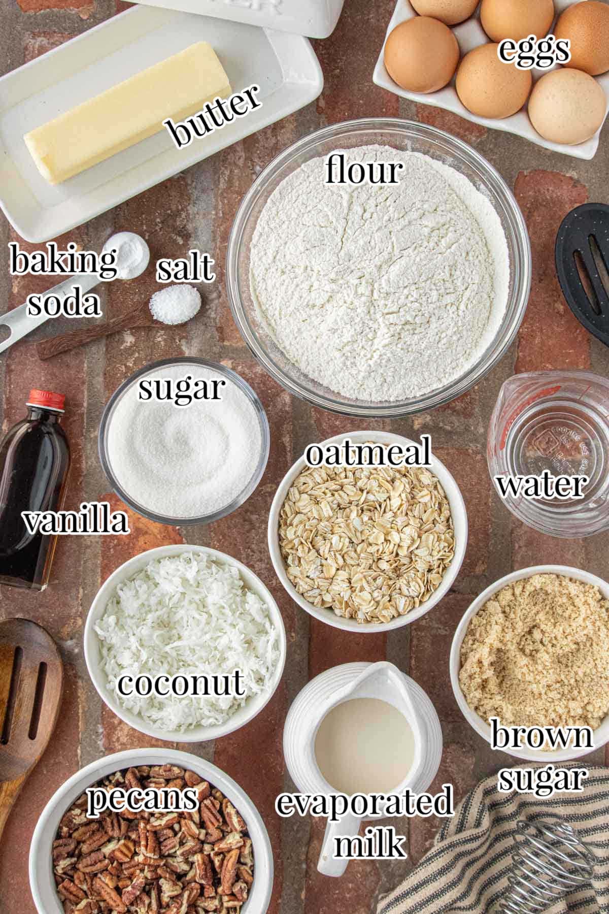 Ingredients for old-fashioned oatmeal cake including oats, flour, sugar, butter, eggs, coconut, pecans, and evaporated milk