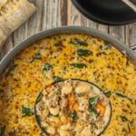 Creamy sausage and white bean soup simmering in a pot with a ladle lifted, overlaid with text reading “Creamy Sausage & White Bean Soup” and “Because adults don’t get snow days,” photographed by Kim Ledet for Marye at Restless Chipotle.