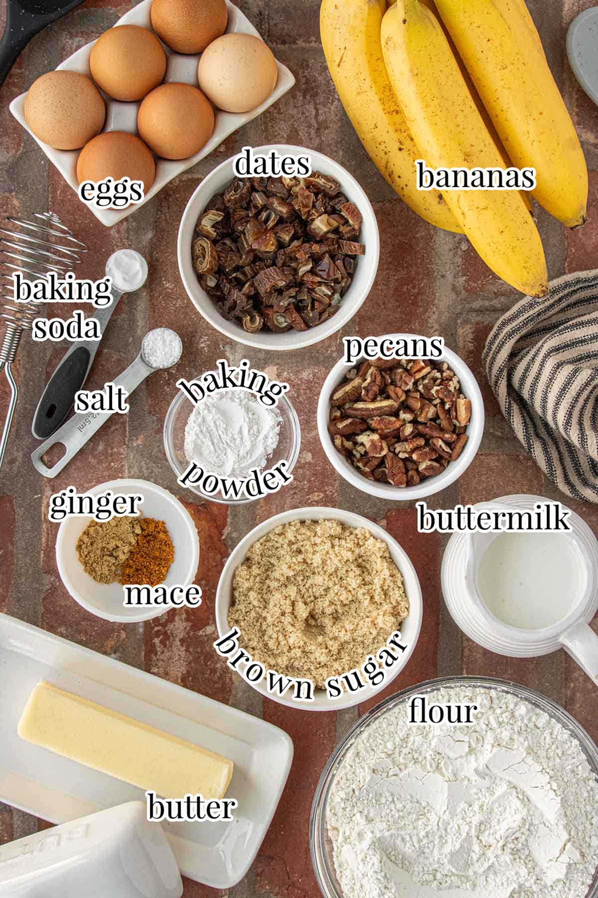 Ingredients for banana date bread including ripe bananas, chopped dates, pecans, brown sugar, flour, eggs, butter, and spices arranged on a rustic surface.