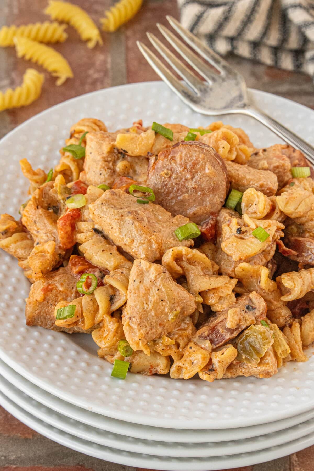 Plated Cajun chicken and sausage pasta dinner with creamy Cajun sauce and sliced smoked sausage