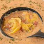 Hearty crockpot tomato tortellini soup with cheese tortellini and tomatoes in creamy broth.