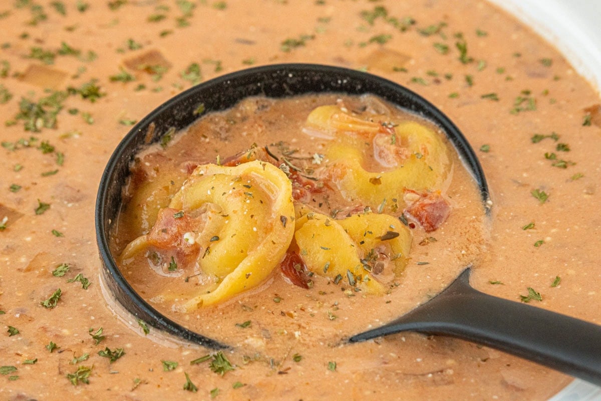 Hearty crockpot tomato tortellini soup with cheese tortellini and tomatoes in creamy broth.