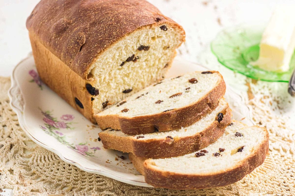Old-fashioned raisin bread loaf with thick slices showing tender crumb and scattered raisins