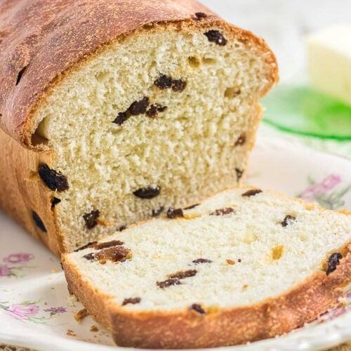 Close-up of soft raisin bread crumb with plump raisins baked into golden homemade loaf