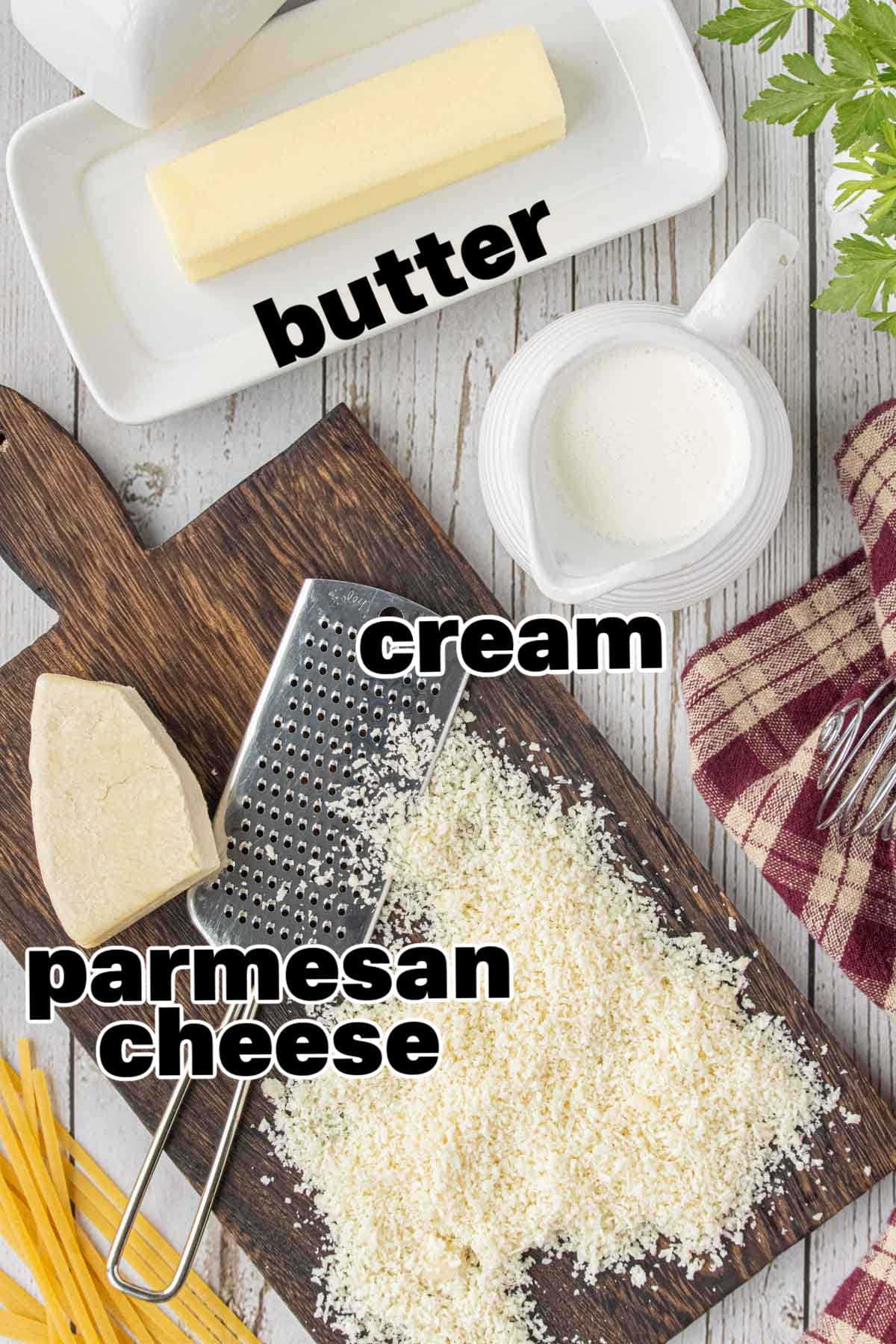 Ingredients for homemade Alfredo sauce including butter cream and Parmesan cheese