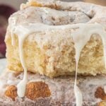 A stack of no yeast cinnamon rolls dripping with glaze with text overlay for pinterest.
