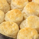Close-up of golden brown 3-ingredient biscuits baked in a cast iron skillet