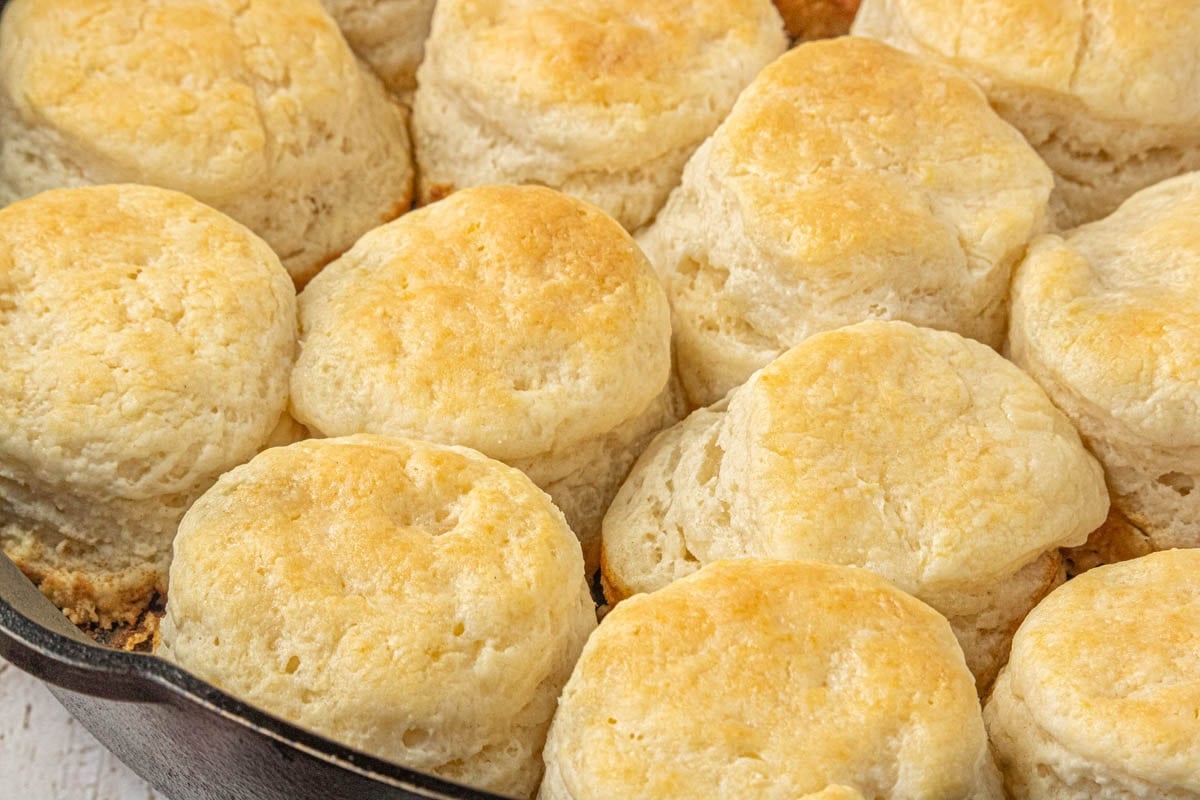 Close-up of golden brown 3-ingredient biscuits baked in a cast iron skillet