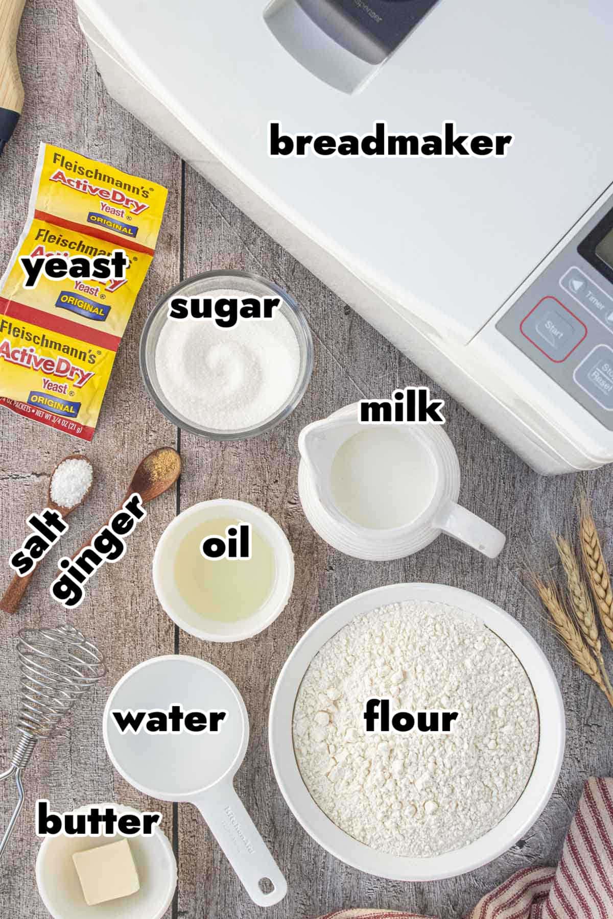Ingredients for Amish white bread in a bread machine including flour, yeast, milk, butter, sugar, ginger, salt, oil, and water.