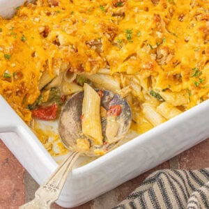 Creamy pimento cheese chicken casserole with broccoli and penne pasta baked with cheddar topping.