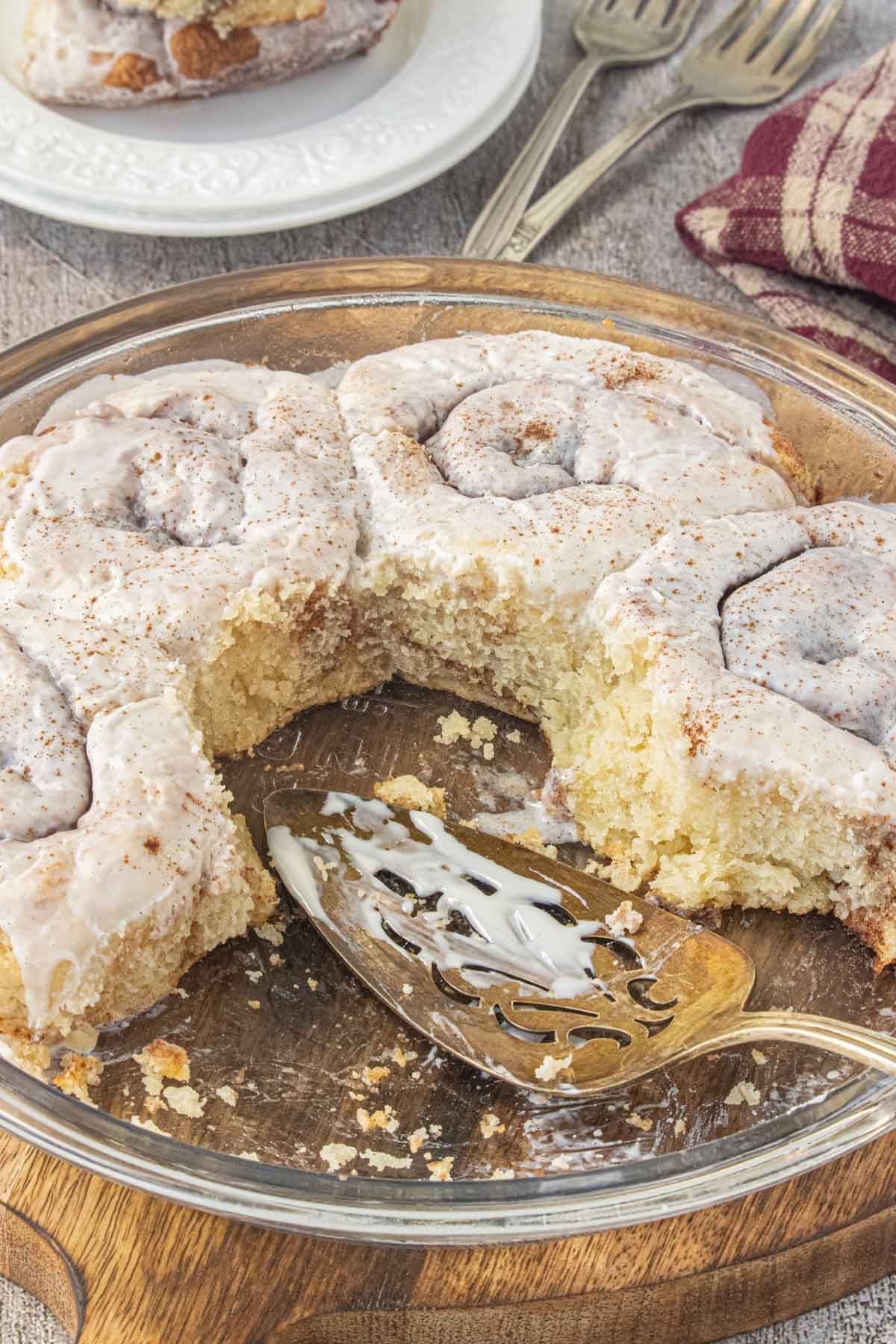 Easy no yeast cinnamon rolls with 2-ingredient dough baked in a round pan and topped with creamy icing.