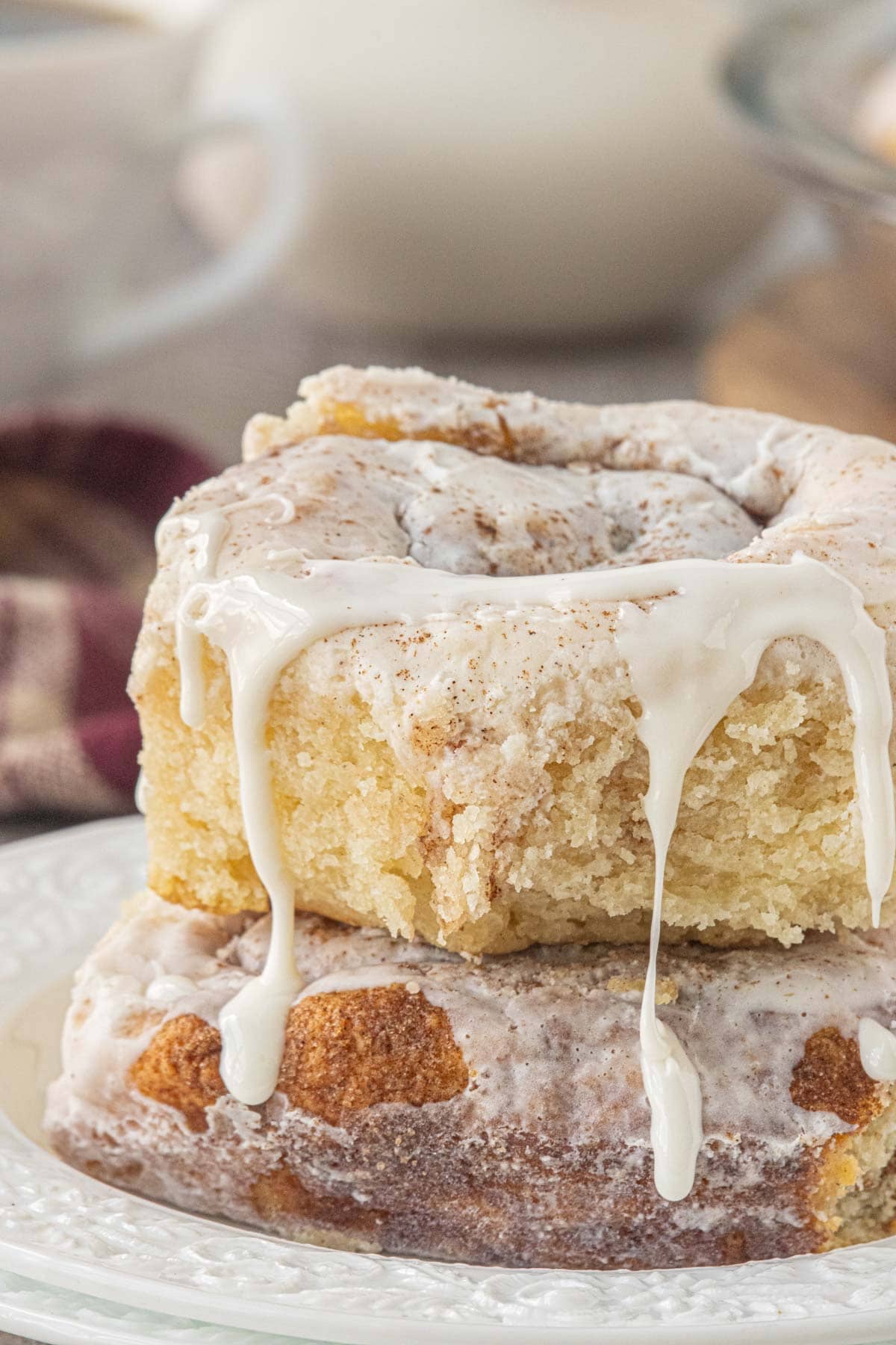 Close-up of soft no yeast cinnamon rolls made with 2-ingredient dough and thick vanilla icing.