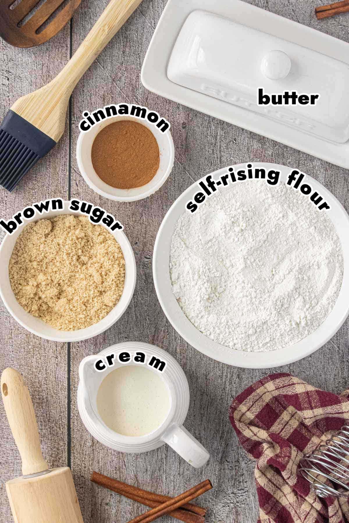 Ingredients for easy no yeast cinnamon rolls including self-rising flour, cream, cinnamon, brown sugar, and butter.