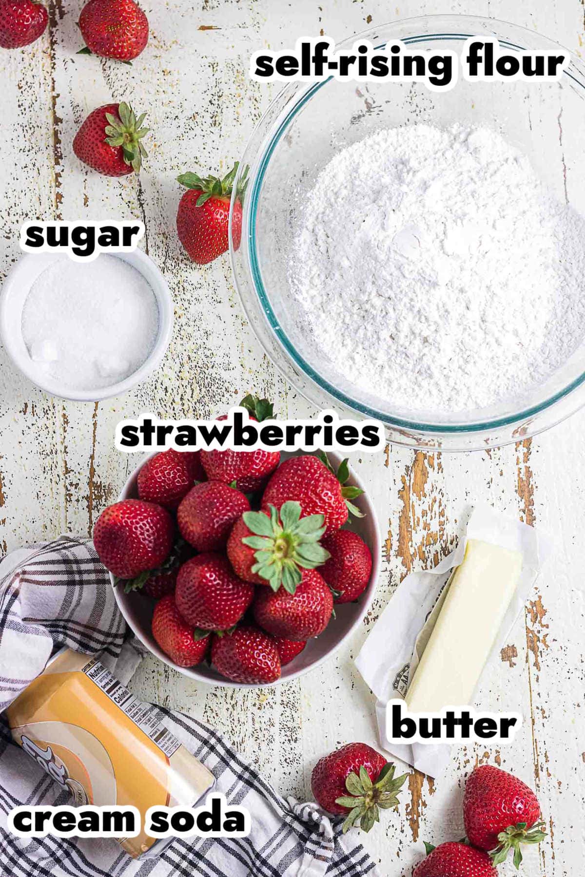 Ingredients for strawberry shortcake with cream soda biscuits including strawberries, butter, flour, sugar, and cream soda