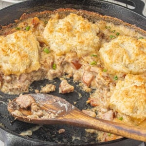 Biscuits and gravy pot pie with smoked sausage and homemade biscuits baked in a cast iron skillet