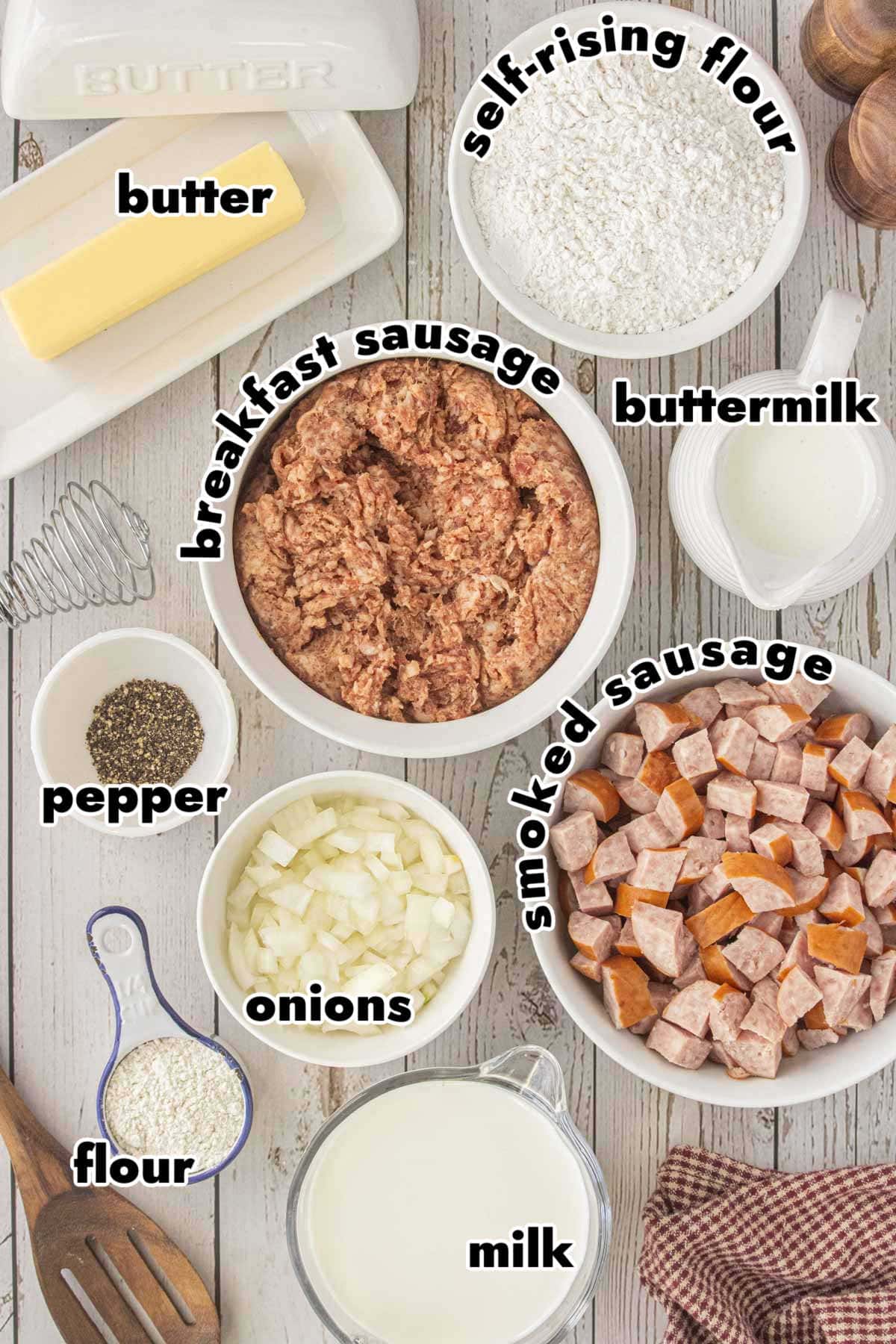 Ingredients for biscuits and gravy pot pie including breakfast sausage, smoked sausage, onions, flour, milk, butter, buttermilk, and self-rising flour
