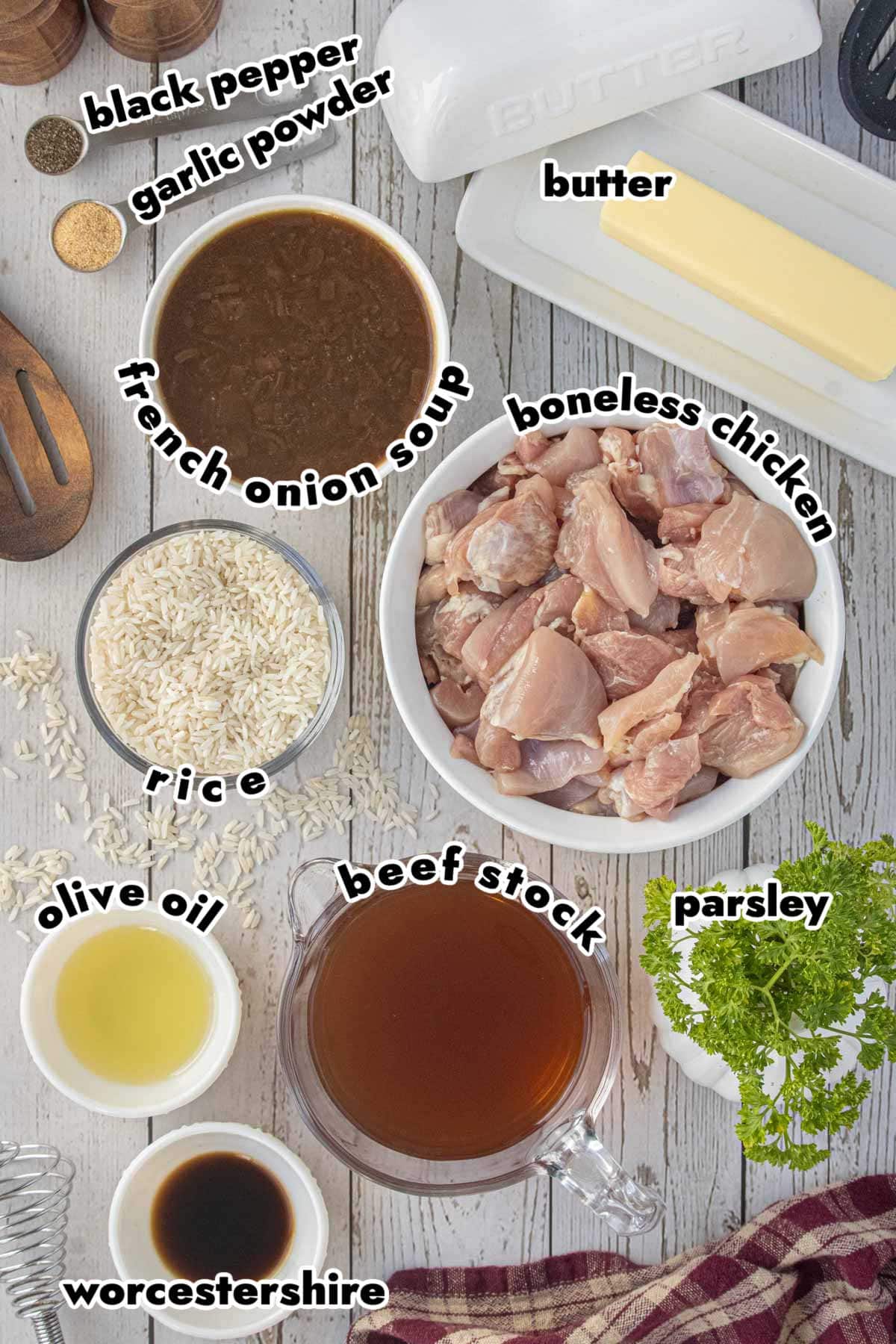 Ingredients for stick of butter chicken and rice casserole including chicken, rice, butter, French onion soup, beef stock, Worcestershire sauce, olive oil, garlic powder, black pepper, and parsley.