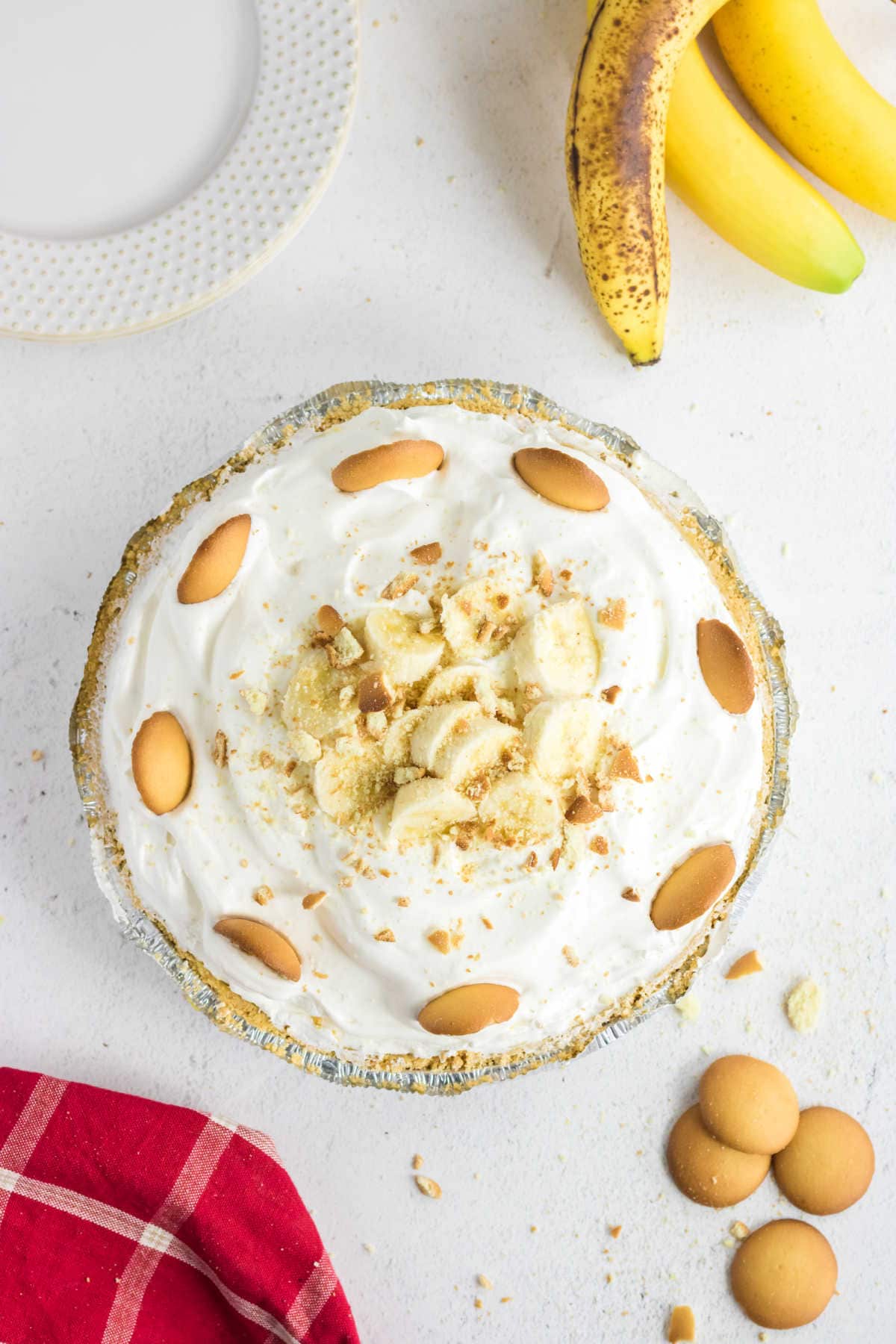 Overhead view of an uncut banana pudding pie with Nilla Wafers and bananas on the top.