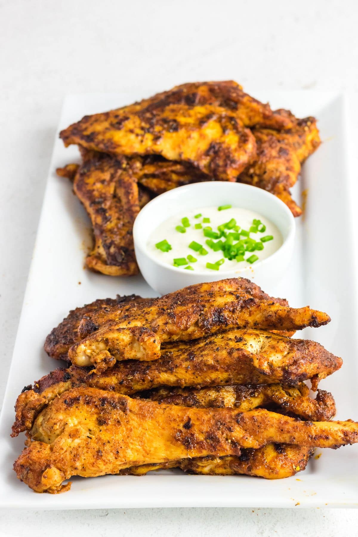 Copycat Popeyes blackened chicken tenders on a serving platter.