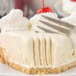 A slice of dr pepper icebox pie garnished with whipped cream and maraschino cherries being cut with a fork. Text overlay for Pinterest.