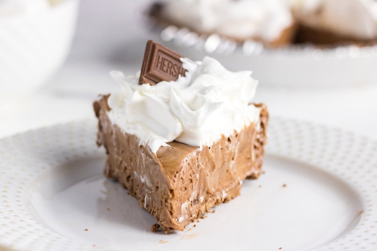 A slice of Hershey's chocolate pie on a white plate.