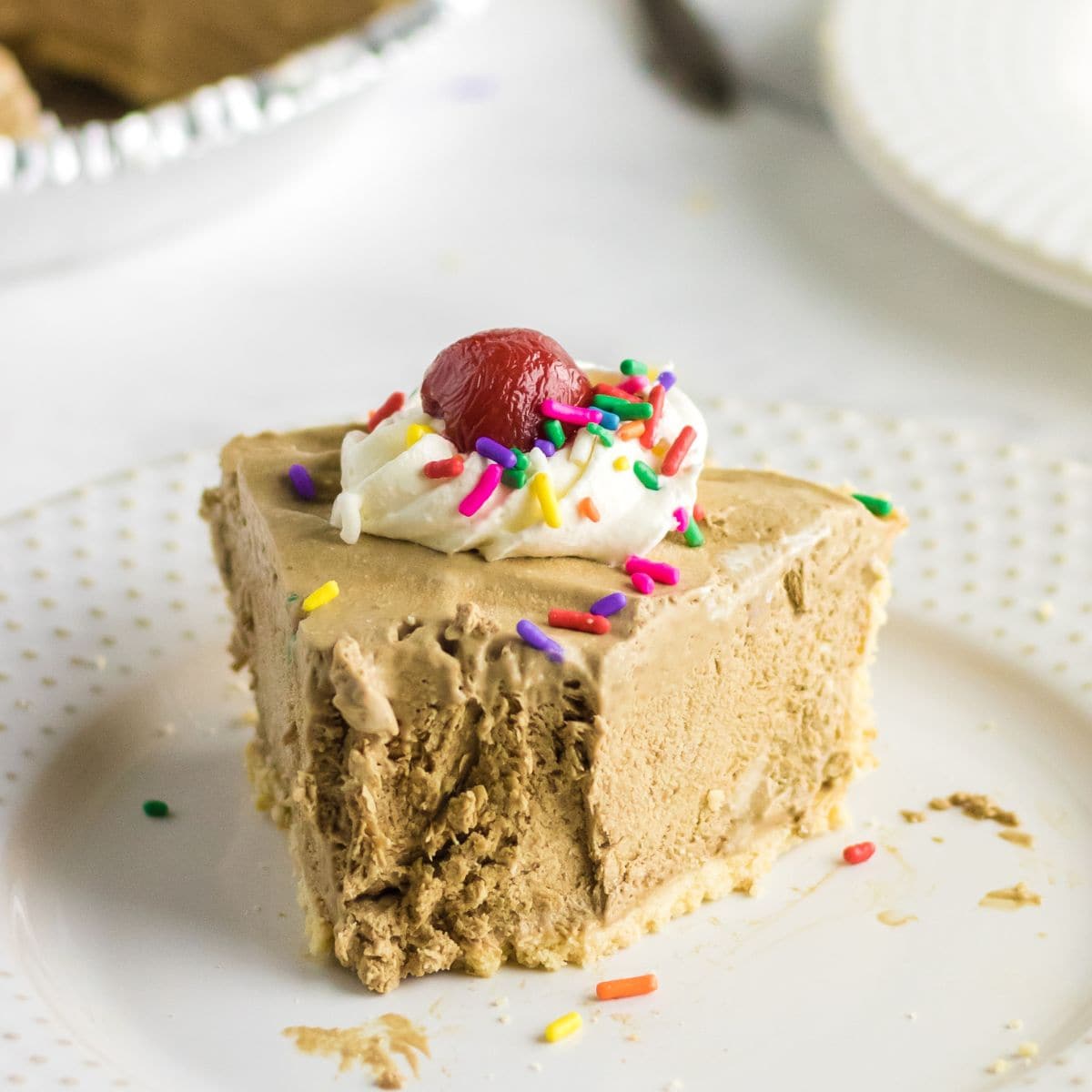 A slice of root beer float icebox pie on a white plate.