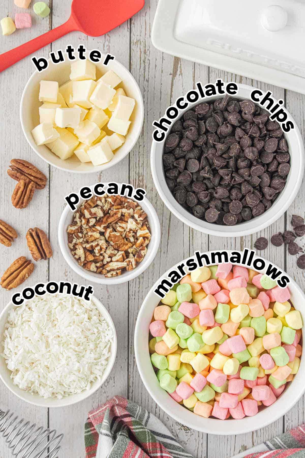 Ingredients for church window cookies including butter, chocolate chips, chopped pecans, coconut, and pastel mini marshmallows.