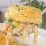 Creamy Crockpot Angel Chicken Pot Pie with shredded chicken, mixed vegetables, and flaky biscuits served from the slow cooker.