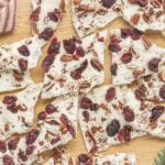 White chocolate cranberry bark recipe with dried cranberries and chopped pecans broken into festive pieces.