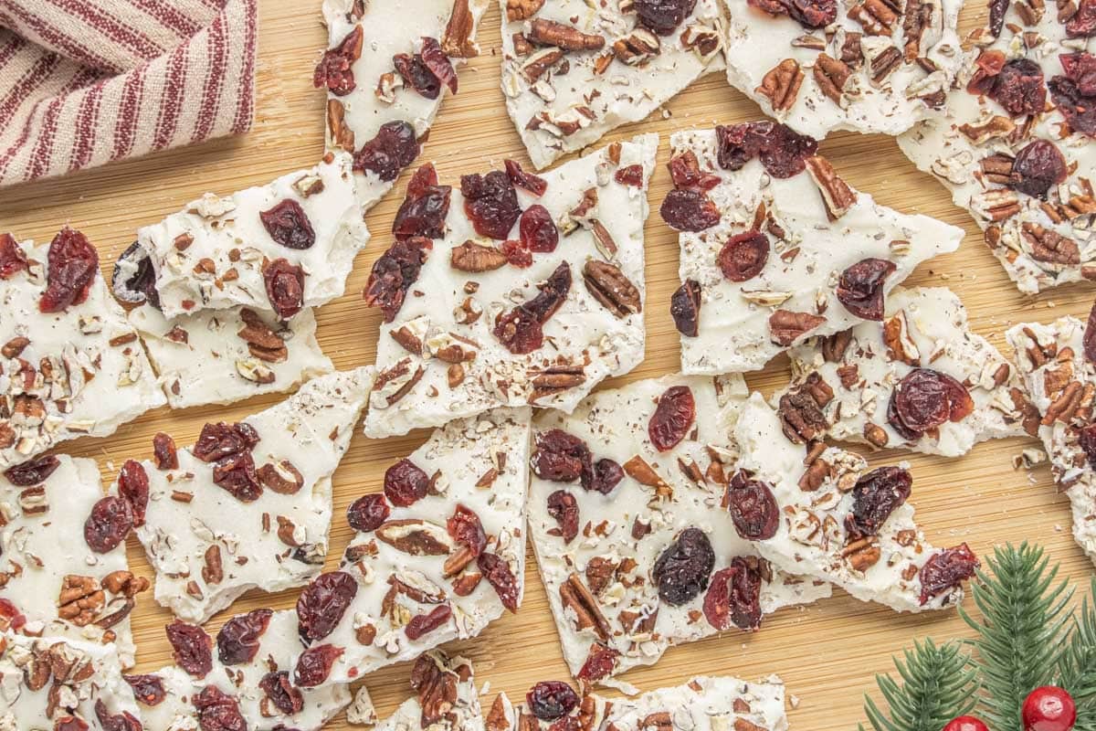 White chocolate cranberry bark recipe with dried cranberries and chopped pecans broken into festive pieces.