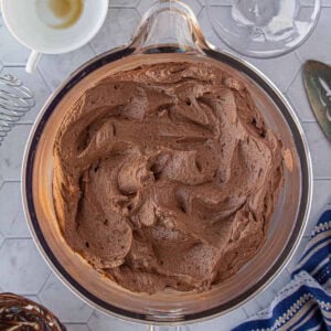 Overhead view of the creamy, chocolate fudge frosting recipe made with sour cream, dark chocolate, cocoa, and coffee.