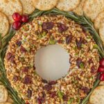 Pinterest pin for a cranberry cheese ball wreath with the text "Nobody Wants the Veggie Tray" over a festive holiday cheese ball appetizer.