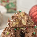 Stacked crockpot candy with a bite taken out to show the interior. Text overlay for Pinterest.