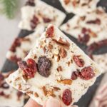 Squares of white chocolate cranberry bark with text overlay for Pinterest.