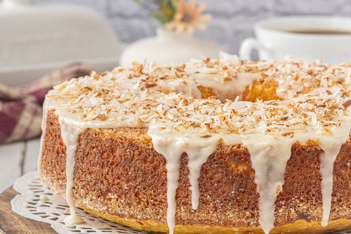 Homemade Louisiana crunch cake topped with creamy vanilla glaze and toasted coconut