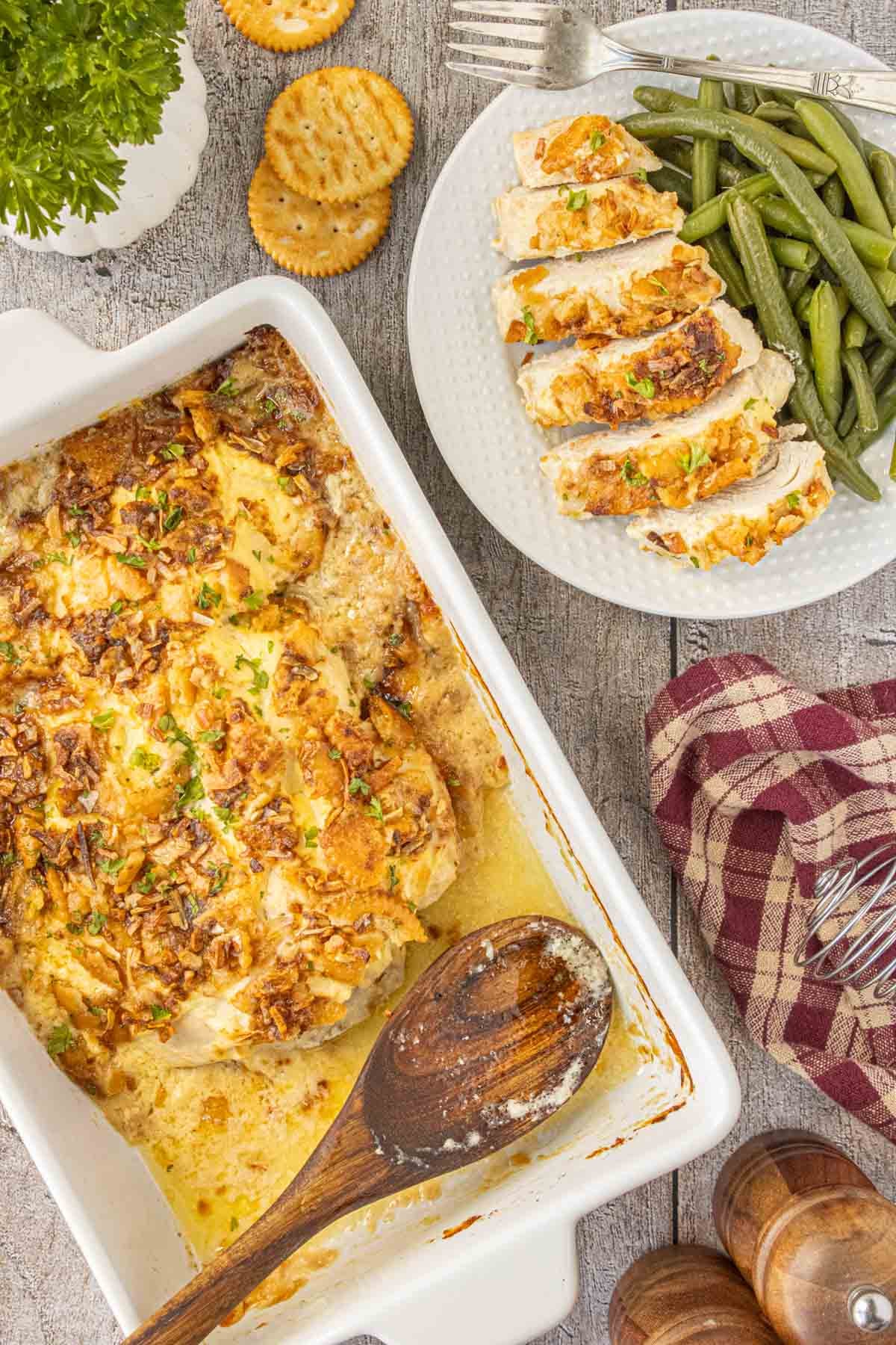 Baked Ritz chicken breasts with golden buttery cracker topping served with green beans