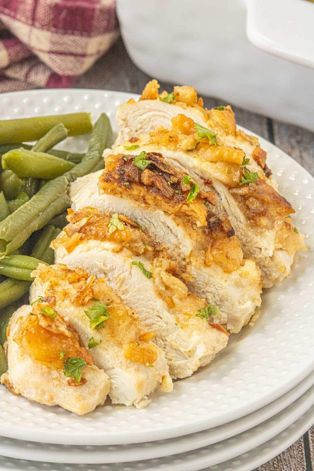 Baked Ritz chicken breasts with golden buttery cracker topping served with green beans