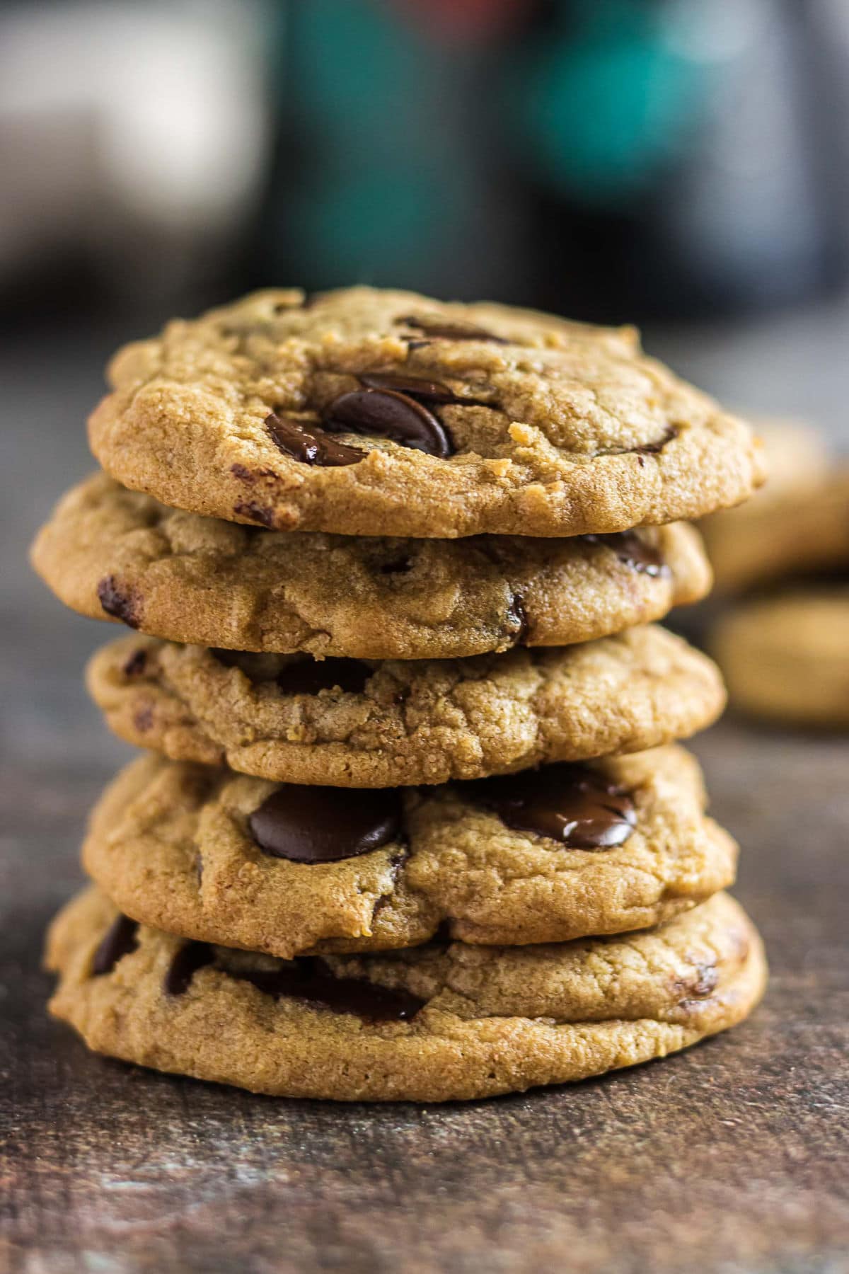 Stack of chewy brown butter chocolate chip cookies with melted dark chocolate chips.