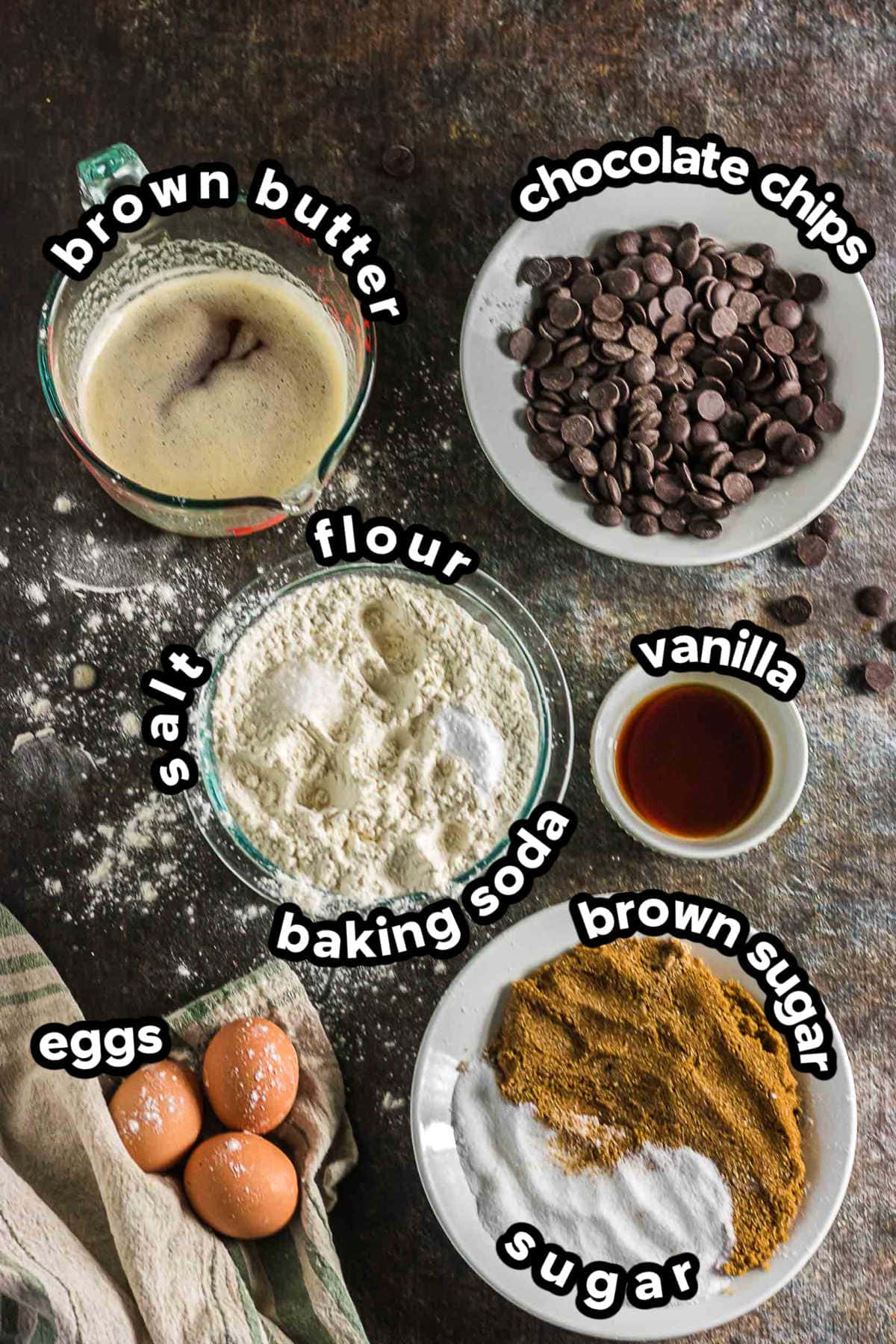 Ingredients for brown butter chocolate chip cookies including browned butter, flour, eggs, brown sugar, sugar, vanilla, and chocolate chips.
